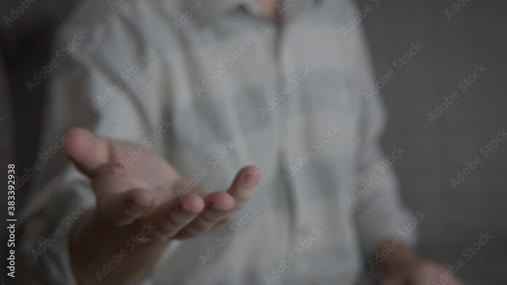 Aggressive man with a fist. A man turns the outstretched hand into a fist in the room. Aggressive man with a fist. A man turns the outstretched hand into a fist in the room.