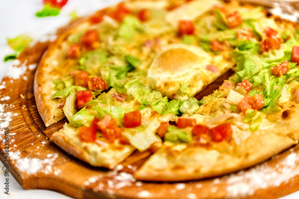 Pizza with bacon meat, egg yolk and green salad Pizza with bacon meat, egg yolk and green salad