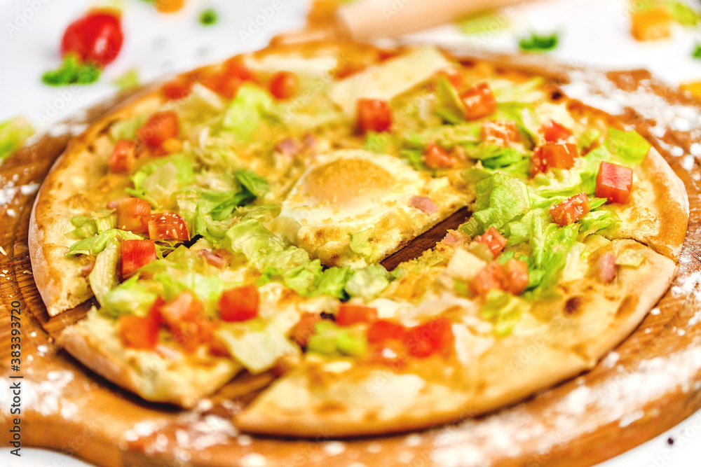 Pizza with bacon meat, egg yolk and green salad