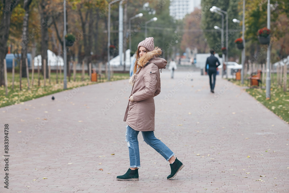 Young pretty woman walking in the autumn park Young pretty woman walking in the autumn park