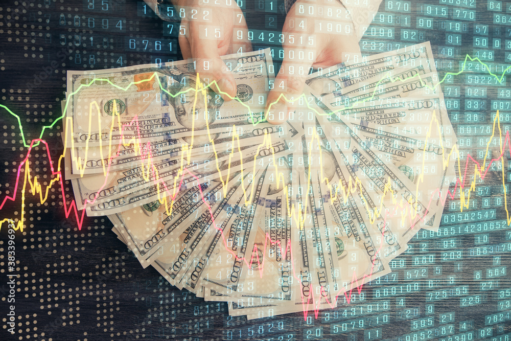 Multi exposure of financial graph drawing hologram and USA dollars bills and man hands. Analysis concept. Multi exposure of financial graph drawing hologram and USA dollars bills and man hands. Analysis concept.