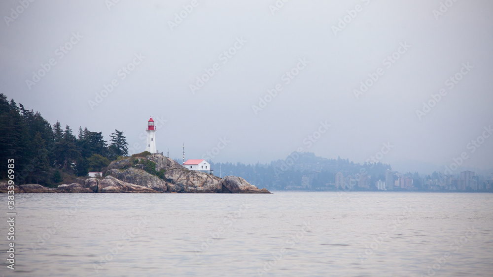 View of the Historic Lighthouse Point Park in West Vancouver off Point Atkinson, British Columbia, Canada. Taken from the water.