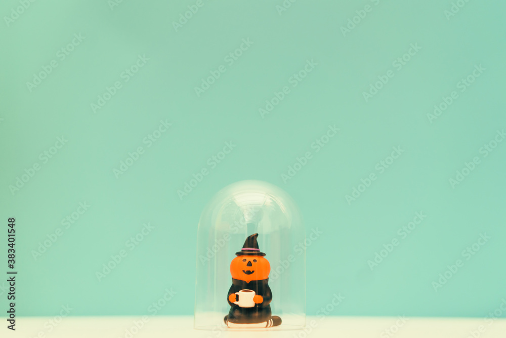 Fototapeta premium jack o lantern holding coffee cup stay home on green background.Stay home stay safe lockdown at home.Relax in holidays halloween party online.Protection from coronavirus covid19 pandemic.Pumpkin witch