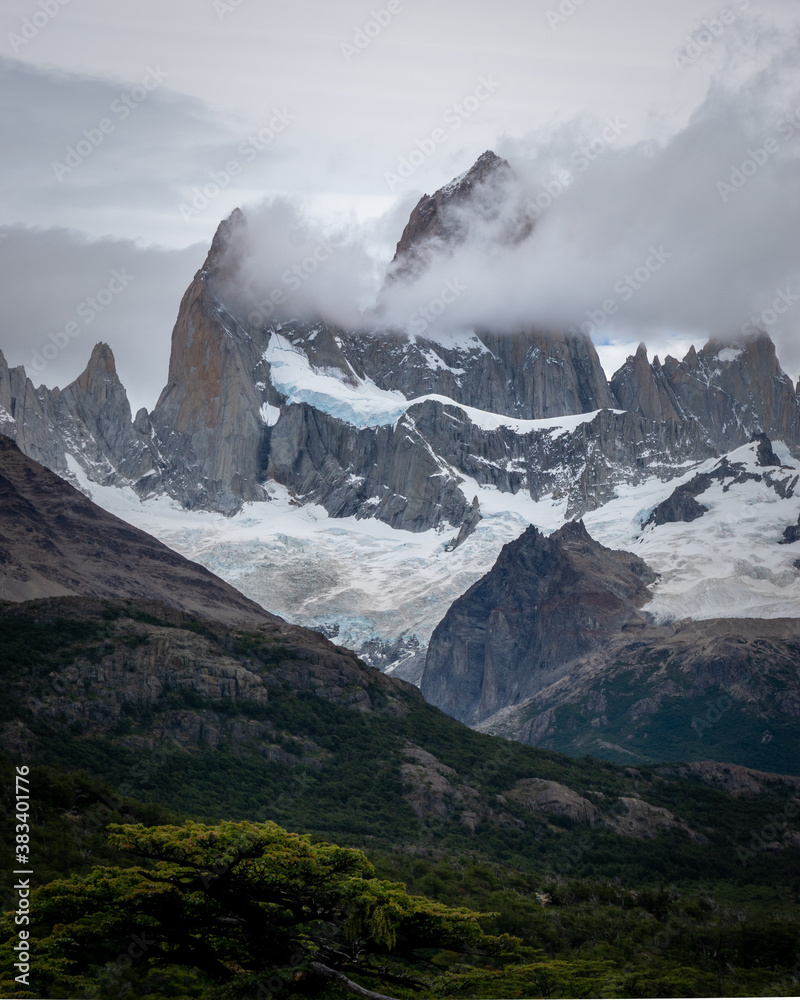 Rocky snowy mountain peaks with the sun rising behind and red clouds. Fitz Roy in Argentina Rocky snowy mountain peaks with the sun rising behind and red clouds. Fitz Roy in Argentina
