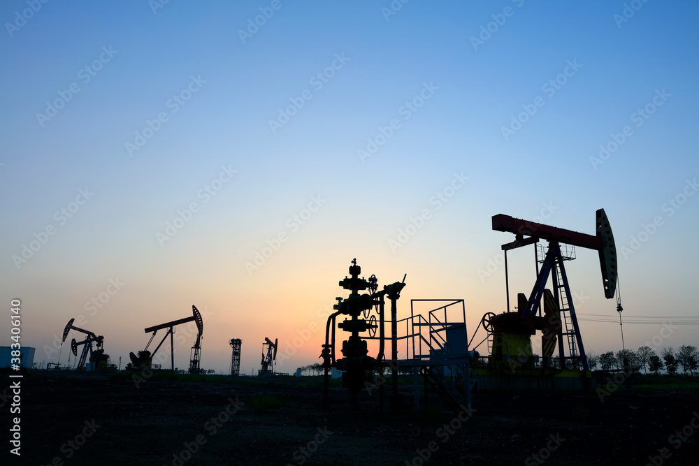 the oil pump in the evening, the evening silhouette of the pumping unit, the silhouette of the oil pump the oil pump in the evening, the evening silhouette of the pumping unit, the silhouette of the oil pump