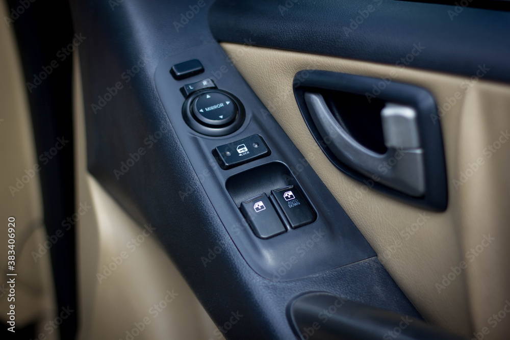 Car arm rest with Control Panel. Door Lock & Mirror Control. window adjustment buttons, door lock. Photography of a modern car.