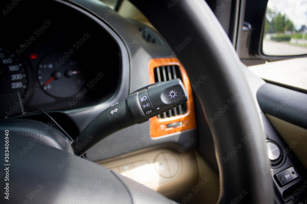 Switch off lights in a car. close-up Car integrated turning indicator with headlight switch toggle. Switch off lights in a car. close-up Car integrated turning indicator with headlight switch toggle.