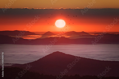 Endless layers of fog and trees within the blue ridge mountains of north carolina. Overlooks give way to a sea of mountains and hills filled with fall color during colorful sunrise and sunsets.