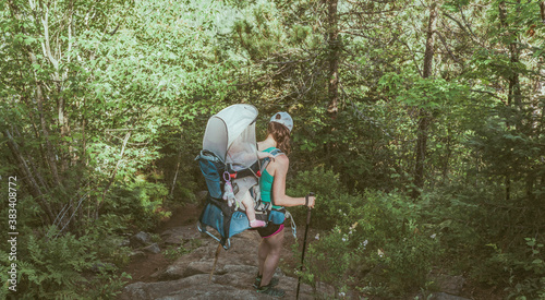 Woman hiking with baby looking at steep decline