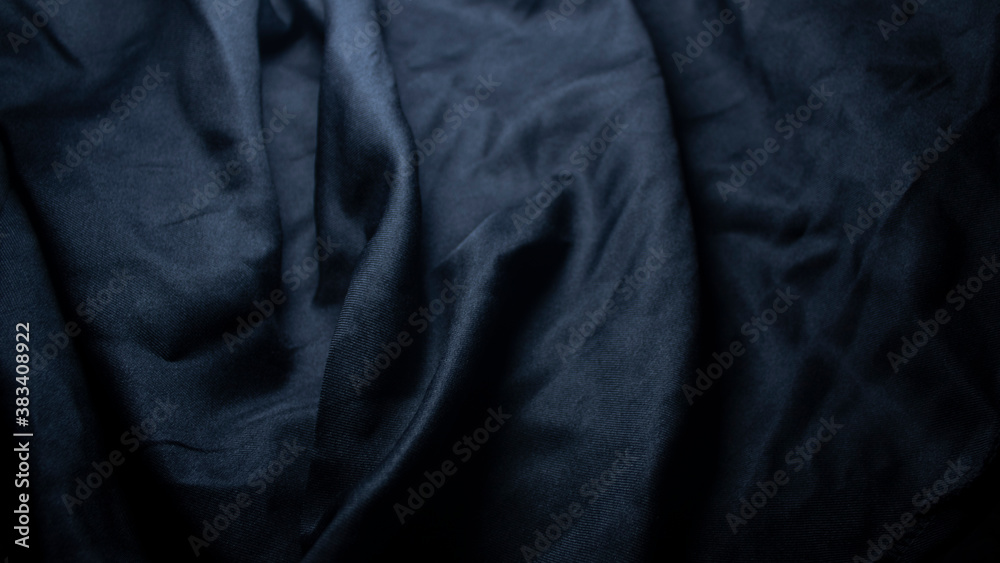 Fototapeta premium The surface of the black cloth with wavy marks