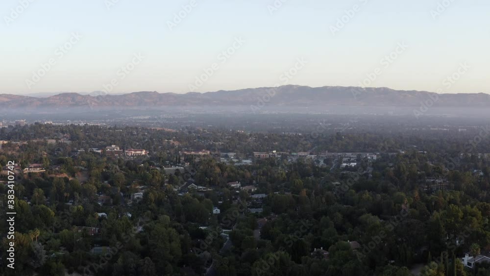 Sunrise from over Corbin Canyon looking to San Gabriel Mountains San Fernando Valley Woodland Hills Suburbs Los Angeles California Drone View Sunrise from over Corbin Canyon looking to San Gabriel Mountains San Fernando Valley Woodland Hills Suburbs Los Angeles California Drone View