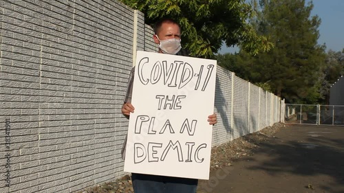 Anti COVID Protester with Mesh Mask - Plan Demic Tracking Shot photo