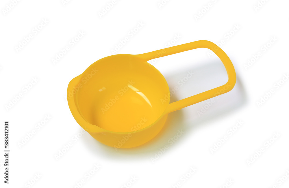 Yellow measuring cup isolated on white background. Yellow measuring cup isolated on white background.