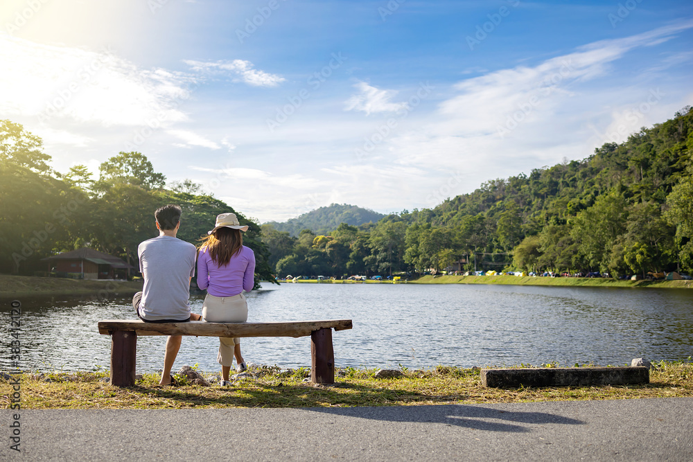 Travelers couple look at the mountain lake. Travel happy emotions Lifestyle concept.