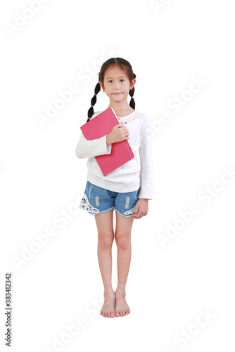 Portrait smiling asian little girl hold book isolated on white background. Kid embracing a notebook.