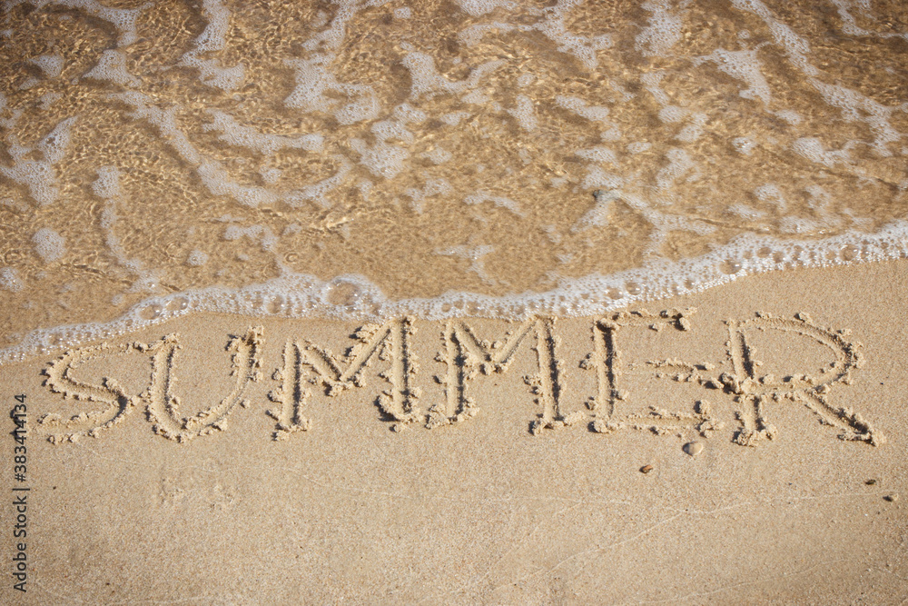 Fototapeta premium Inscription summer and incoming sea wave on sand at beach. Travel and vacation time