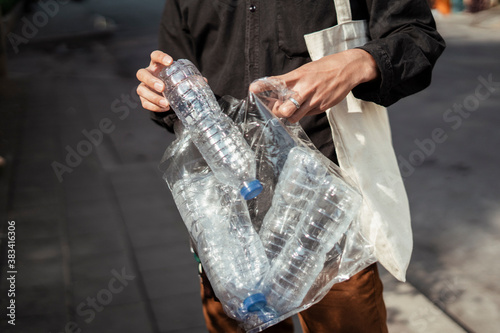Man collect plastic bag on street.