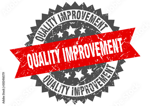 quality improvement stamp. grunge round sign with ribbon