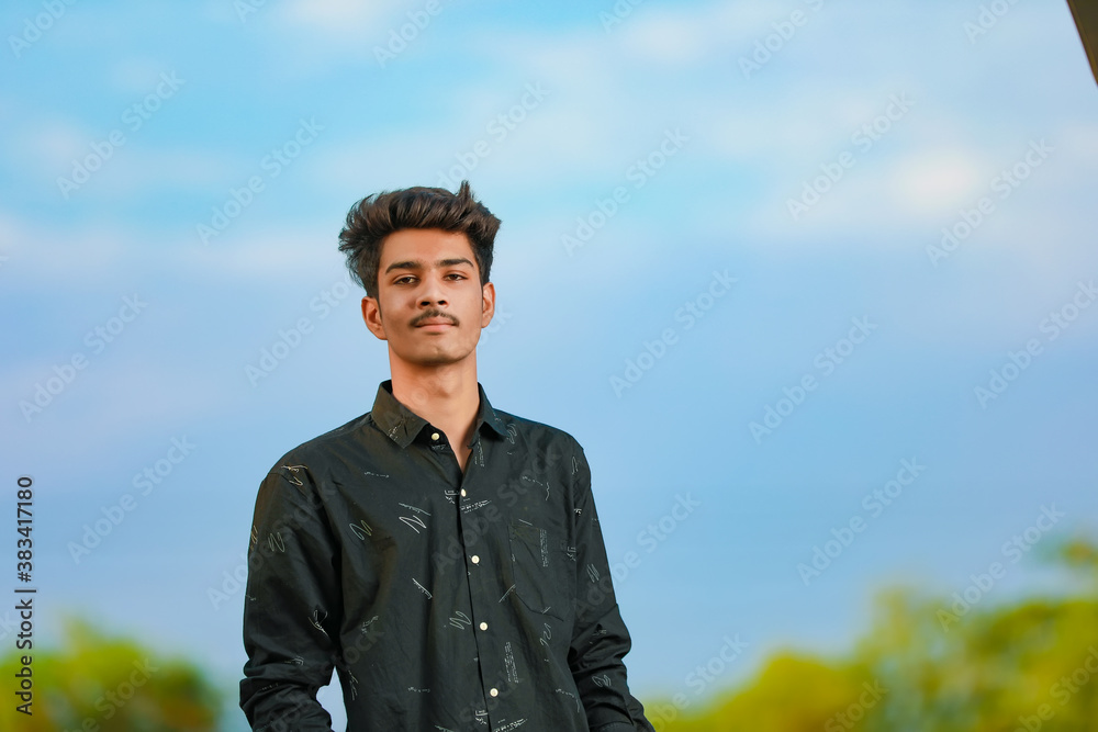 Young handsome indian man wearing black shirt Young handsome indian man wearing black shirt