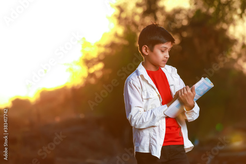 Fototapeta Naklejka Na Ścianę i Meble -  Indian Asian school boy with note book and studying at home