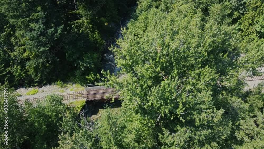 Aerial view of the railroad, bridge and the wild river in canadian forest Aerial view of the railroad, bridge and the wild river in canadian forest