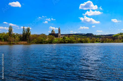 Fototapeta Naklejka Na Ścianę i Meble -  View of the beautiful lake and old orthodox church on a shore