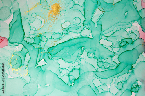 Alcohol ink green and gold abstract background. Drops watercolor texture.