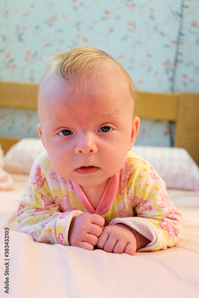 portrait of a cute baby child infant on the bed with funny face portrait of a cute baby child infant on the bed with funny face