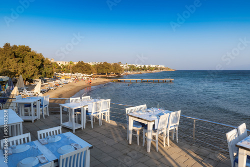 Sea view beach restaurant at sunset in Akyarlar beach, Bodrum, Turkey.