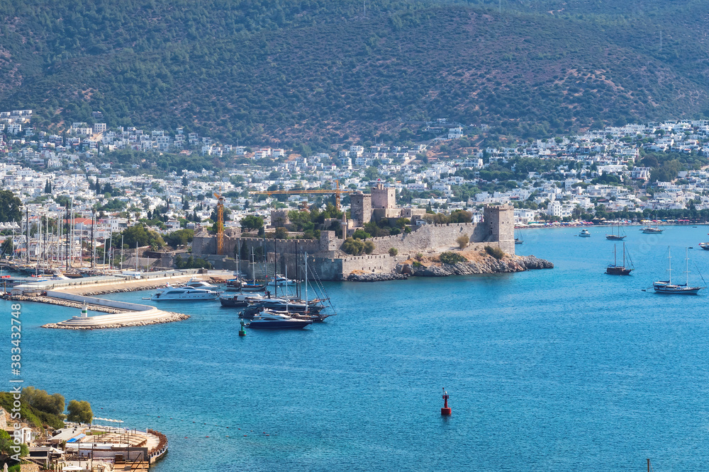 Bodrum Castle and Marina with sailboats and luxury yachts in harbor on the Aegean sea