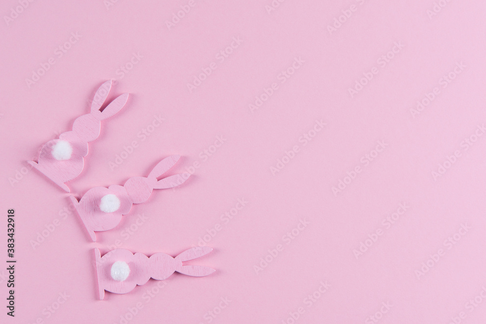 Pink Easter bunnies on pink background, easter greeting card, top view with copy space