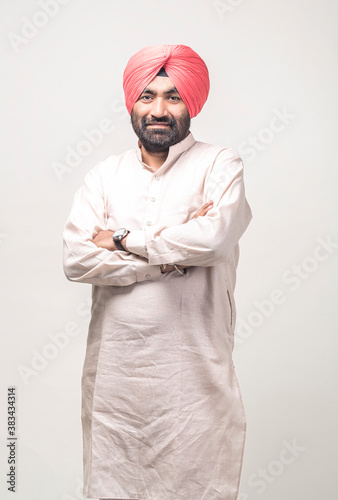 Studio portrait of a sikh handsome man looking at camera with smile