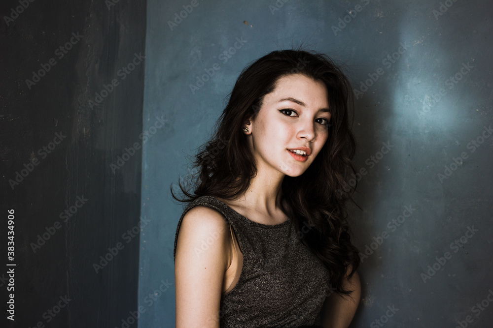 Black hair woman. Beautiful brunette hairstyle fashion portrait over dark background