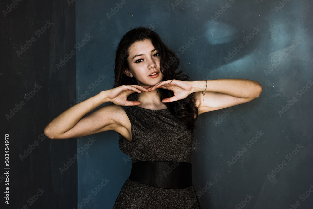 Black hair woman. Beautiful brunette hairstyle fashion portrait over dark background