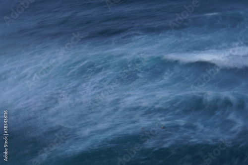 Abstract seascape of stormy blue water with waves