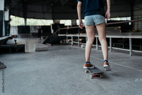 Skate board player woman moving on a board.