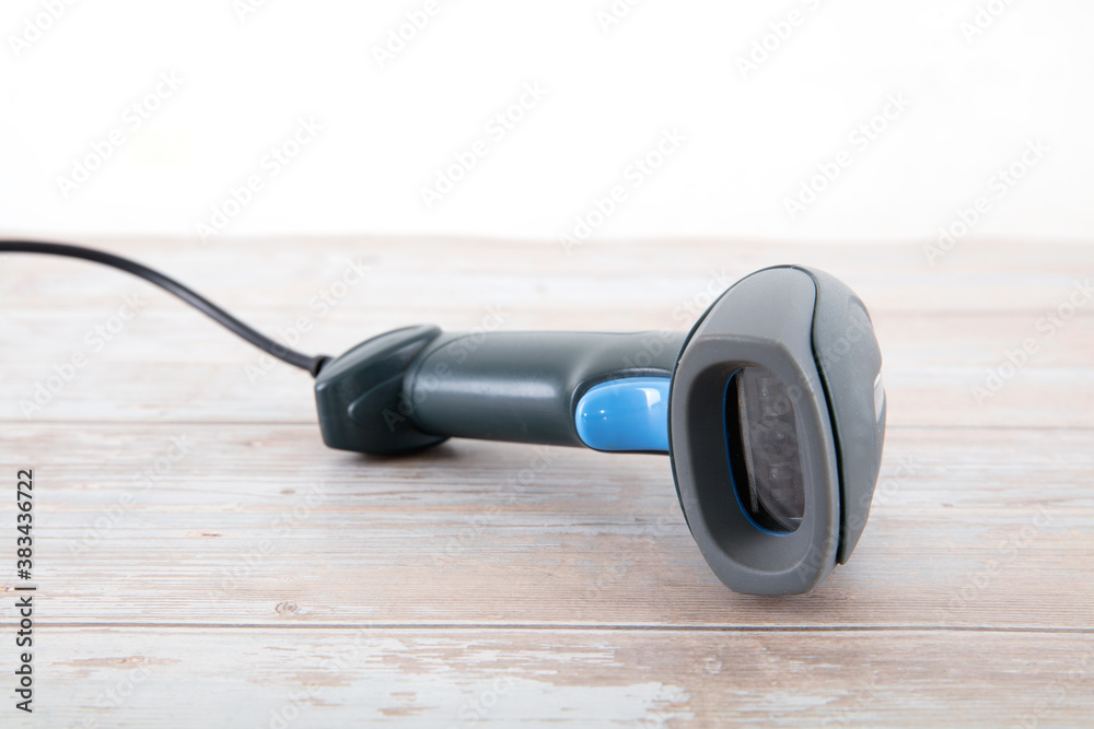 A blue barcode scanner cash register tool on the table