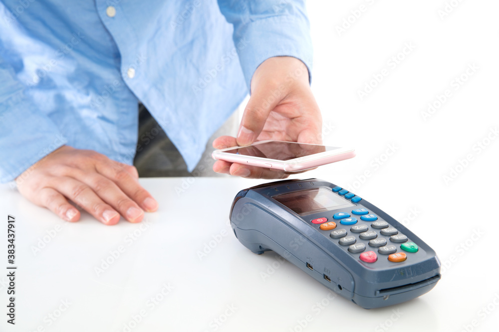 Hand holding mobile phone and scanning payment on pos machine on white background Hand holding mobile phone and scanning payment on pos machine on white background