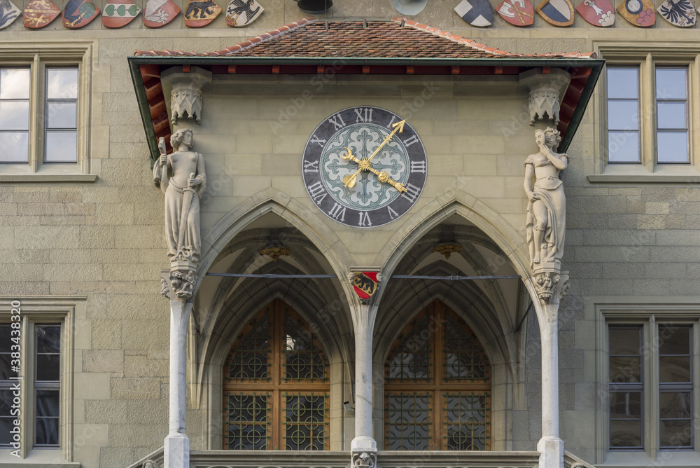 statues and clock on the facade of the Town hall of Bern, Switzerland