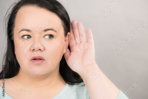 Woman overhearing listening to rumors.