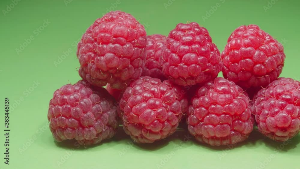 Raspberry close-up. Green background. 4K video. Raspberry close-up. Green background. 4K video.