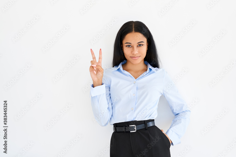 Happy smiling black businesswoman doing victory sign on white background