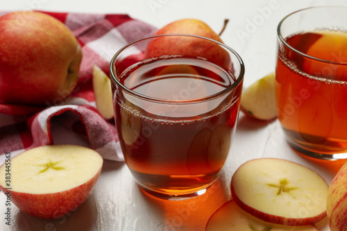 Glasses of fresh apple juice on white background
