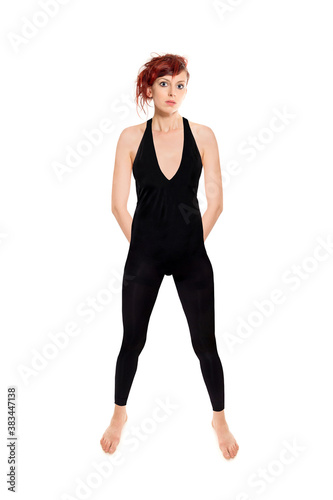 Full length portrait of an attractive woman wearing a black bodysuit, studio photo isolated in front of white background