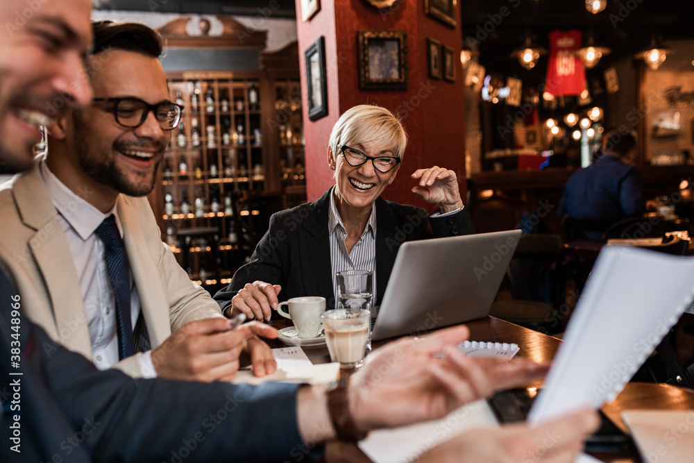 Business people holding a meeting at office cafeteria discussing about business plan.