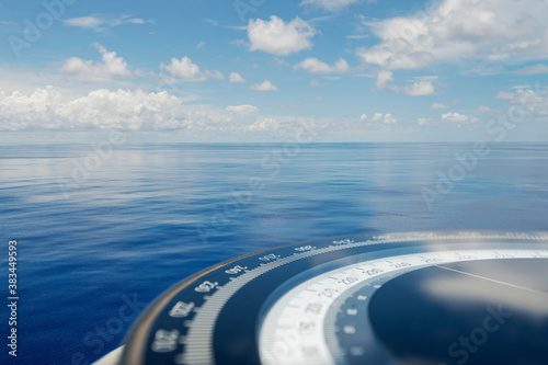 Compass on ship boat blue summer sea ocean day with bright sky. Marine navigation cruise background banner. Shipping industry concept.