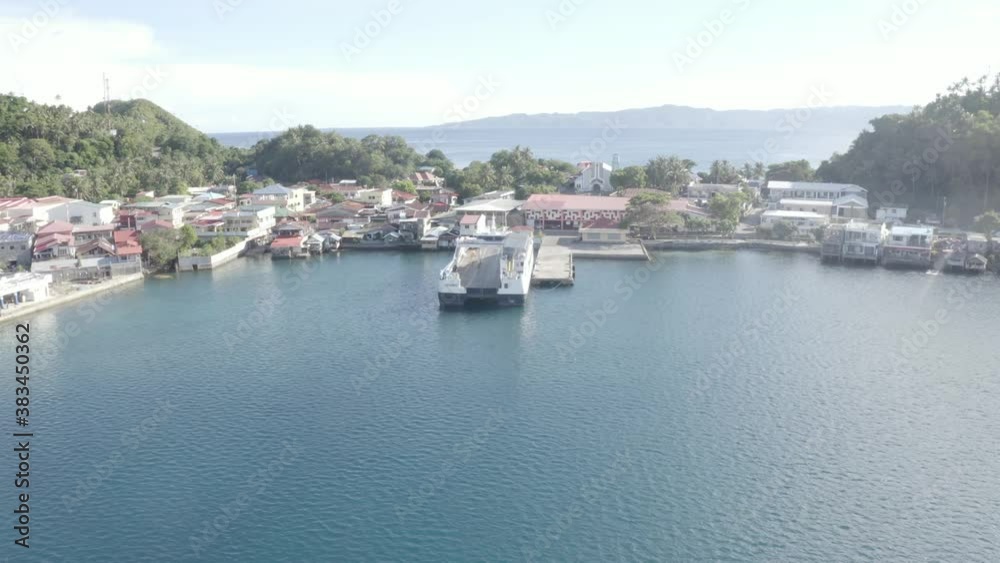 Drone Flying Towards A Local Fastcat Ferry Boat Docked At The Pier Of A Tropical Island In Southern Leyte, Philippines During COVID-19 Pandemic - Aerial Drone Forward Shot Drone Flying Towards A Local Fastcat Ferry Boat Docked At The Pier Of A Tropical Island In Southern Leyte, Philippines During COVID-19 Pandemic - Aerial Drone Forward Shot