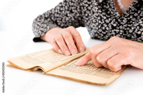 Картината върху платно The old man is flipping through an old yellowed book