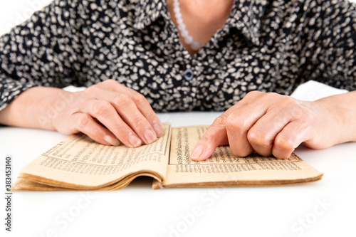 Картината върху платно The old man is flipping through an old yellowed book
