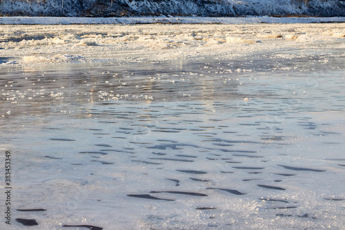Sparkling ice texture or background. Ice hummock on Frozen River in winter sunny day.